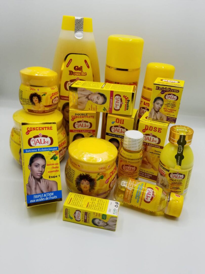 A group of yellow beauty products on top of each other.