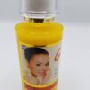 A bottle of facial oil with a picture of a woman.