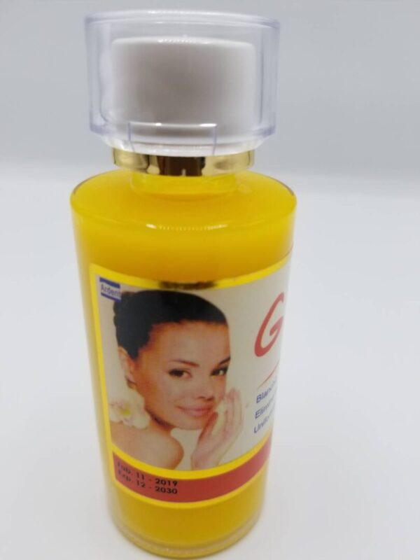 A bottle of facial oil with a picture of a woman.