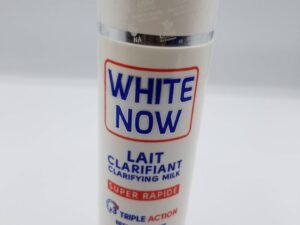 A bottle of white now lotion on top of a table.