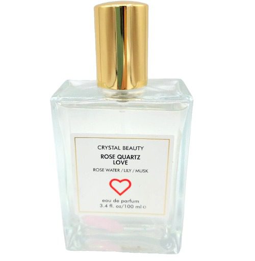 A bottle of CRYSTAL BEAUTY ROSE QUARTZ LOVE ROSE eau de parfum with a heart on it.