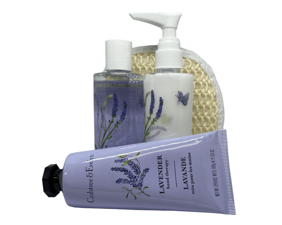 A CRABTREE & EVELYN 3pc Lavender Hand Therapy Body Wash And Lotion Essentials Collection, including two pump bottles and a tube of cream, displayed in front of a textured sponge. Set cleanses and moisturizes skin.