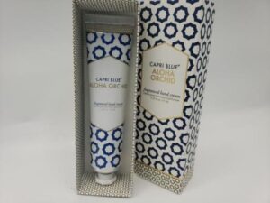 A tube of CAPRI BLUE ALOHA ORCHID fragranced hand cream crème pour les mains parfumée 1.25 A oz / 37 ml in a box.