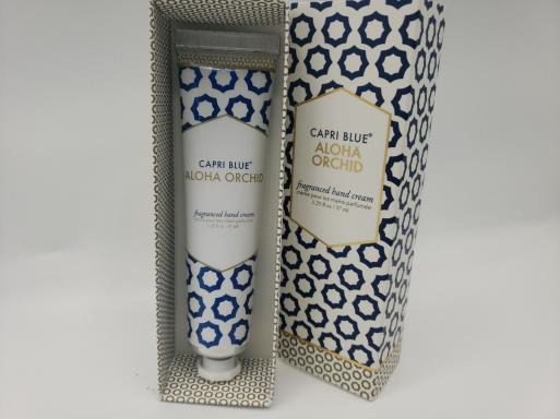 A tube of CAPRI BLUE ALOHA ORCHID fragranced hand cream crème pour les mains parfumée 1.25 A oz / 37 ml in a box.