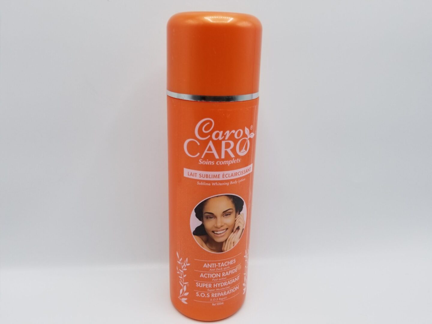 A bottle of Caro Caro Soins Complets Sublime Whitening Body Lotion 500ml on a white background.