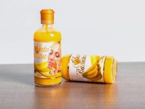 A bottle of GLUTA BANANA 100ML lotion with a banana on it.