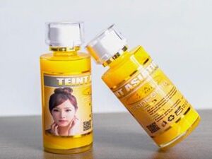 A bottle of Teint Asiatique AHA+Vitamine C Concentré with a woman's face on it.