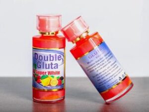 Two bottles of DOUBLE GLUTA SUPER WHITE MULTI-VITAMINES GLUTA 100ml on a table.