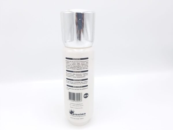 A bottle of Peau de Lune lotion with a silver cap, displaying ingredient information on its label, set against a plain white background.