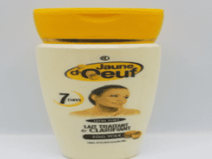 Jar of Jaune d'Oeuf Extra Strong Treatment & Clarifying Milk with a yellow lid, labeled in french, featuring an image of a woman's face on the label.