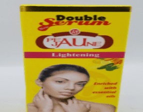 A package of Peau Jaune Double Serum Lightening Triple Action cream featuring an image of a woman and text highlighting its enriched essential oils.