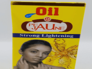 Box of "Peau Jaune Essential Oil Strong Lightening Triple Action 60ml" with an image of a woman on the front, and a sunflower graphic.