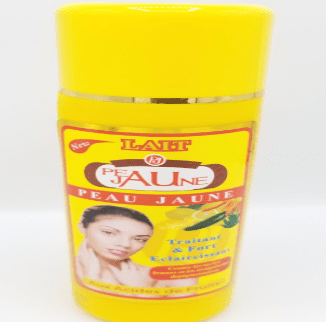 A yellow bottle of Peau Jaune Lait Traitant & Fort Eclaircissant 500ml skin lightening cream with a picture of a woman's face and text detailing product benefits.