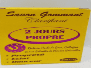 Box of "2 Jours Propre Savon Clarifying Scrub Soap 2 DAYS CLEAN" soap, highlighting its key ingredients like coconut oil and plant extracts, aimed at skin clarity and softness.