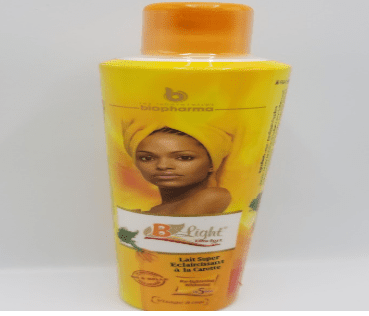 A bottle of B Light Extra Fort Carrot Super Lightening Body Milk - 500ml, featuring a photo of a woman with a headwrap, standing in front of a yellow background.