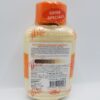 A bottle of lotion with orange and white writing.