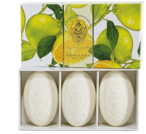 Three bars of soap in a box with lemons on them.